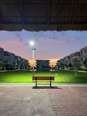 a park bench sitting in a park with a street light at Sunset Malaga beach house in Mansouria