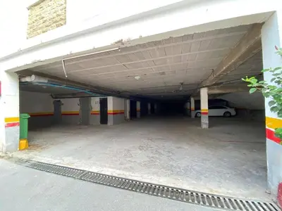 an empty parking garage with a car parked in it at Sunset Malaga beach house in Mansouria