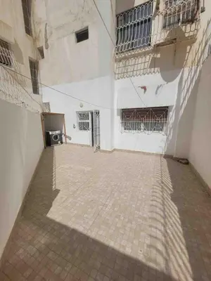 an empty courtyard of a building with barred windows at Cozy Condo in Rabat in Rabat
