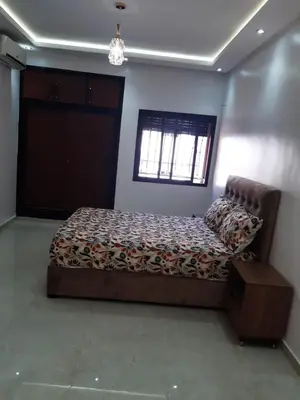 a bedroom with a bed and a window at Appartement 3 chambres et Salon sans ascenseur 3 mn à pied au Parc du Mohammedia in Mohammedia