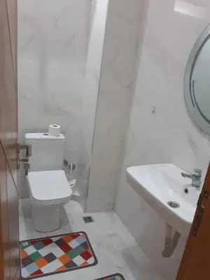 a bathroom with a toilet and a sink at Appartement 3 chambres et Salon sans ascenseur 3 mn à pied au Parc du Mohammedia in Mohammedia