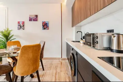 a kitchen with a table and two chairs in a kitchen at Studio vert chic au cœur de Casablanca in Casablanca