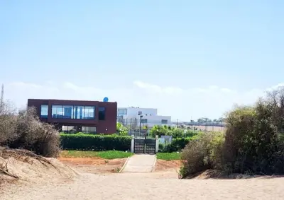 a house on a beach with a pathway leading to it at Blue beach in Bir Jedíd Saint-Hubert