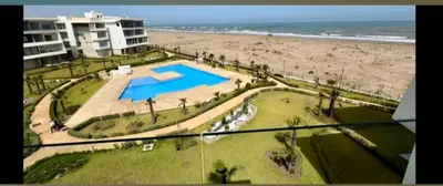 an aerial view of a resort with a swimming pool and the beach at Dokkali
