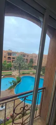 a view of a swimming pool from a balcony at 2 bedrooms apt Ricoflores Mimosa in Mohammedia