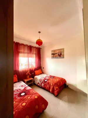 a bedroom with two beds and a window at Appt moderne 3 chbr Blanca Beach in Sidi Rahal
