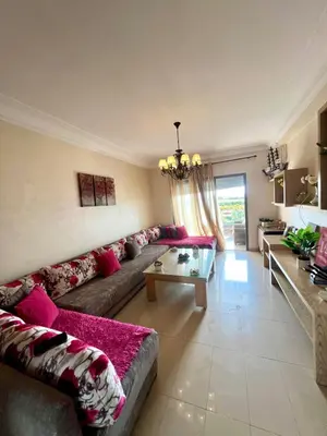 a living room with a couch and a table at Appt moderne 3 chbr Blanca Beach in Sidi Rahal
