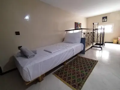 a large white bed in a room with a rug at Studio with Swimmingpool in Harhoura in Temara