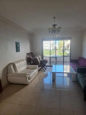 a living room with a couch and a table at Appartement Confortable à Tamaris Piscine, Jacuzzi, Proche de la Mer in Tamaris