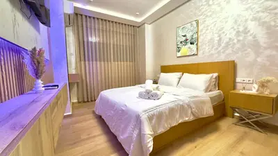 a bedroom with a large white bed and a table at 1min walk B&B City Center in Casablanca