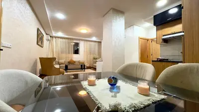 a living room with a glass table and two chairs at 1min walk B&B City Center in Casablanca