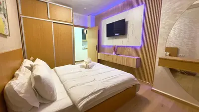 a bedroom with a large bed with a purple lighting at 1min walk B&B City Center in Casablanca