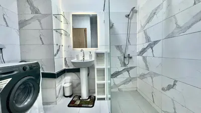 a bathroom with a sink and a washing machine at 1min walk B&B City Center in Casablanca
