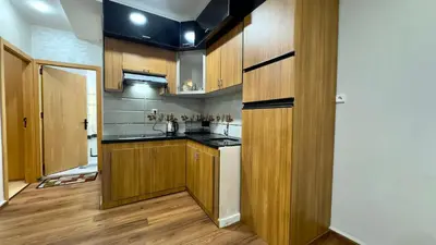 a small kitchen with wooden cabinets and a kitchen at 1min walk B&B City Center in Casablanca