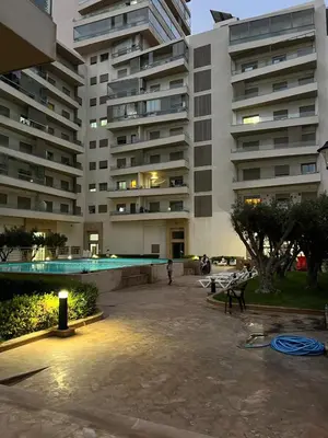 a large building with a swimming pool in front of it at Zenata tower in Casablanca