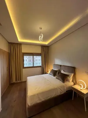 a bedroom with a large bed and a window at Zenata tower in Casablanca