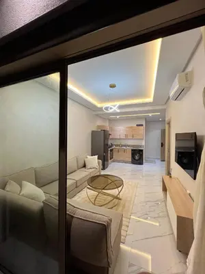 a living room with a couch and a table at Zenata tower in Casablanca