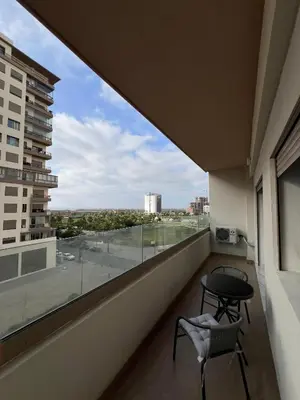 a balcony with a table and chair and a view at Zenata tower in Casablanca
