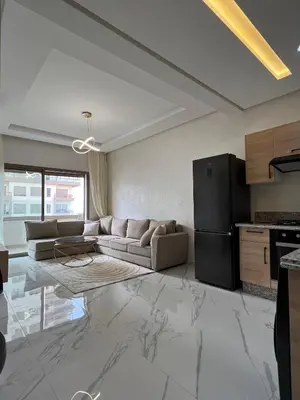 a living room with a couch and a refrigerator at Zenata tower in Casablanca