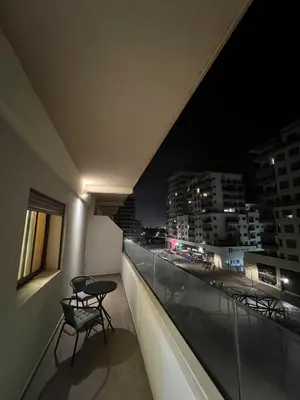 a balcony with two chairs and a table at night at Zenata tower in Casablanca