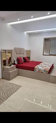 a bedroom with a large bed with red sheets at Exclusive Luxury Suite in Rabat City Center in Rabat
