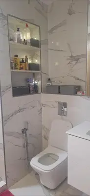 a white bathroom with a toilet and a sink at Exclusive Luxury Suite in Rabat City Center in Rabat
