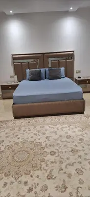 a large bed in a bedroom with a rug at Exclusive Luxury Suite in Rabat City Center in Rabat