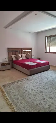a bedroom with a large bed and a rug at Exclusive Luxury Suite in Rabat City Center in Rabat