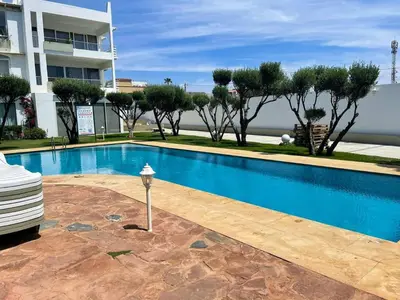 a swimming pool in front of a building at Luxury Sea View in Tamaris