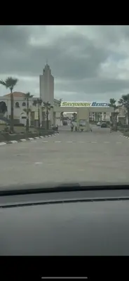 a view of a parking lot with a large building at Savannah beach in Dar Hamida