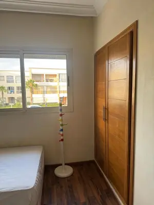 a bedroom with a bed and a dresser and a window at Savannah beach in Dar Hamida