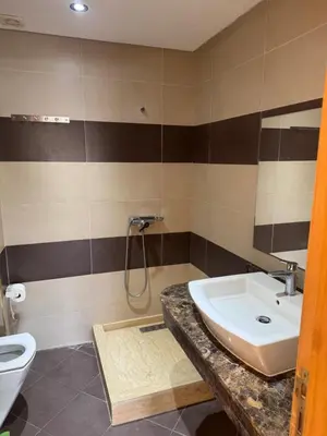 a bathroom with a sink and a toilet at Savannah beach in Dar Hamida