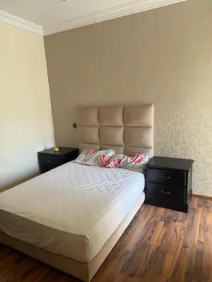 a bedroom with a large bed with two night stands at Savannah beach in Dar Hamida