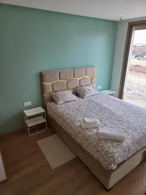 a bedroom with a large bed with two towels on it at Le CasaStud' in Casablanca