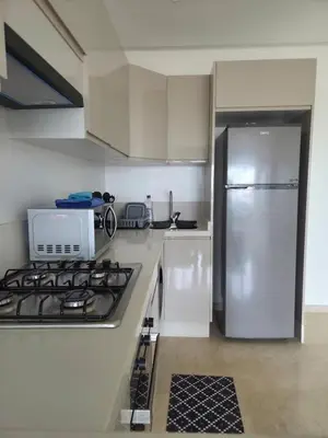 a kitchen with a stove and a refrigerator at Le CasaStud' in Casablanca