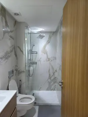 a bathroom with a toilet and a glass shower at Le CasaStud' in Casablanca