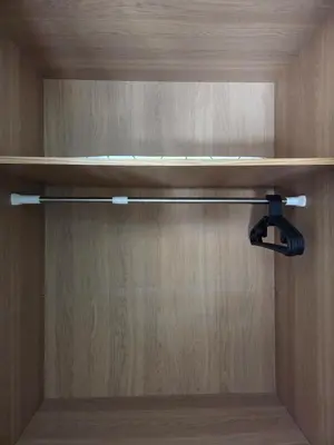 a closet with a wooden door with a shelf at Le CasaStud' in Casablanca