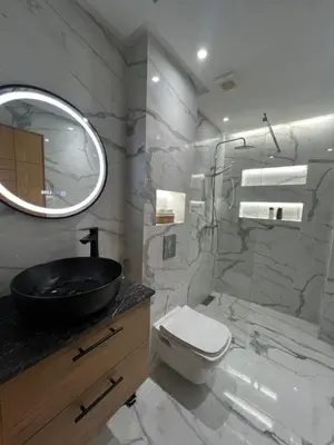 a bathroom with a sink toilet and a mirror at Magnifique appartement 2 chambres vue sur piscine - Sidi Rahal in Sidi Rahal