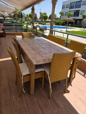 a wooden table and chairs on a deck at Mansouria in Mohammedia