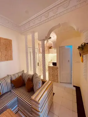 a living room with a couch and a kitchen at Pleasant Studio in Casablanca in Casablanca