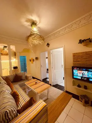 a living room with a couch and a tv at Pleasant Studio in Casablanca in Casablanca