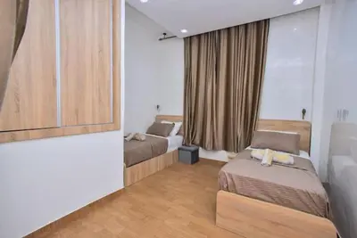 a hotel room with two beds and a window at Appartement Authentique & Moderne au Cœur de la Médina in Casablanca