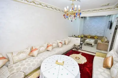 a living room with a couch and a chandelier at Appartement Authentique & Moderne au Cœur de la Médina in Casablanca