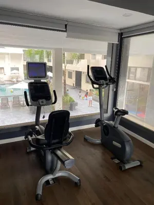 a gym with two exercise bikes and a treadmill at M'ocean Sea View Apartment by 7AV Hotels in Mohammedia