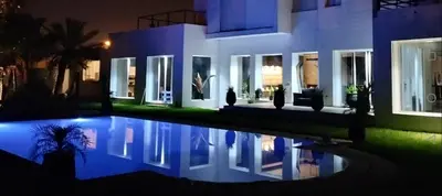 a house with a swimming pool at night at Luxury Villa with pool 6 min to Football Stadium CAF in Rabat