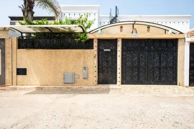 a building with a large black door with a gate at Coastal Moroccan Retreat with Ocean Views in Rabat
