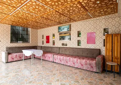 a couch in a room with a table and paintings at Coastal Moroccan Retreat with Ocean Views in Rabat