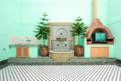 a fountain in a room with potted plants at Coastal Moroccan Retreat with Ocean Views in Rabat