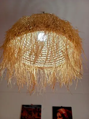 a large straw chandelier hanging from a ceiling at Chez Basma in Rabat