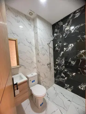 a bathroom with a white toilet and a sink at Apparemment propre pour location pour les familles in Casablanca